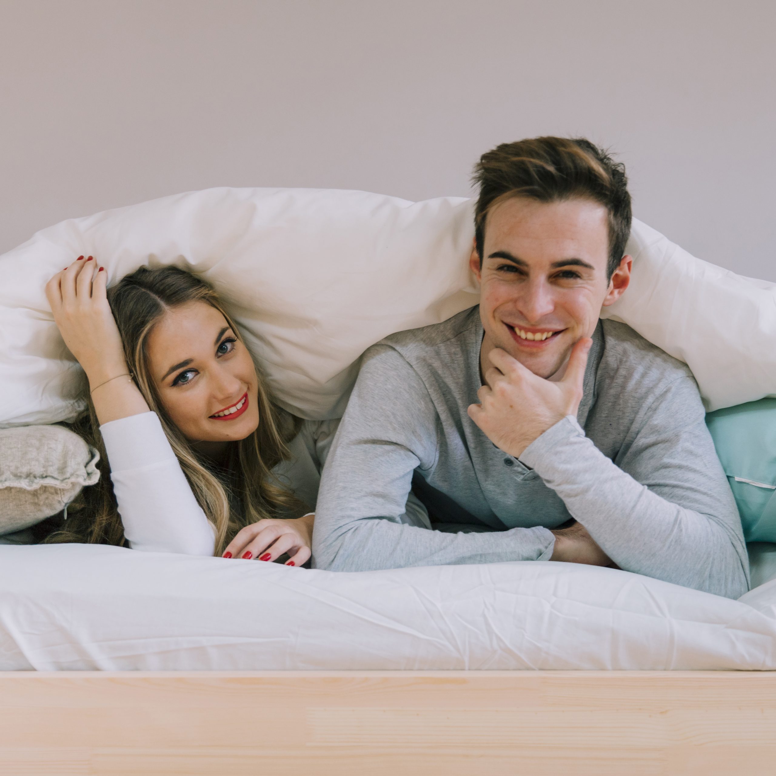 cheerful-couple-posing-blanket